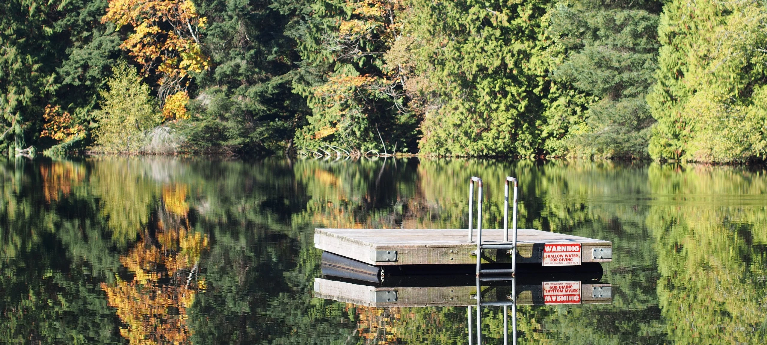 Dock floating on lake during autumn in Nanaimo, BC