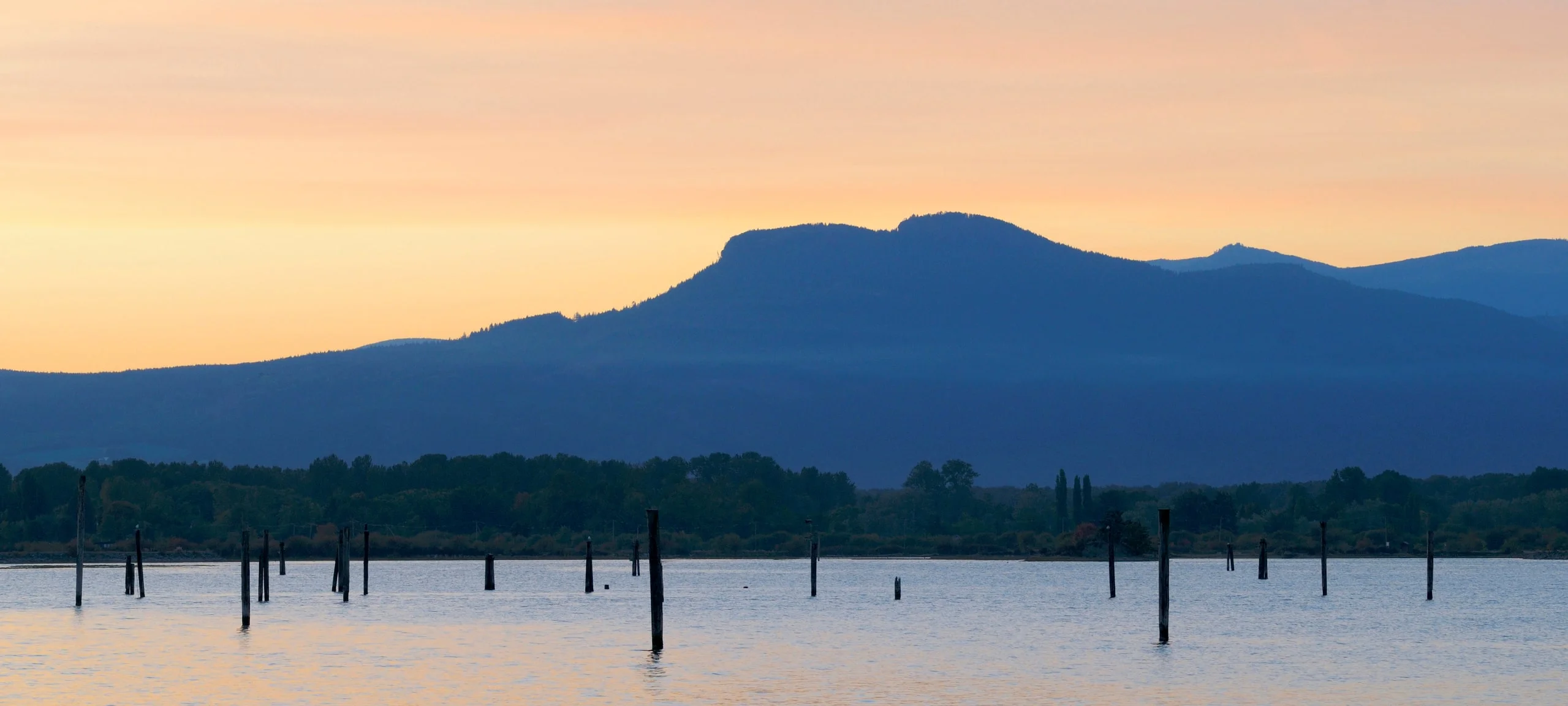 Sunset over mountain silhouette and Cowichan Lake, BC