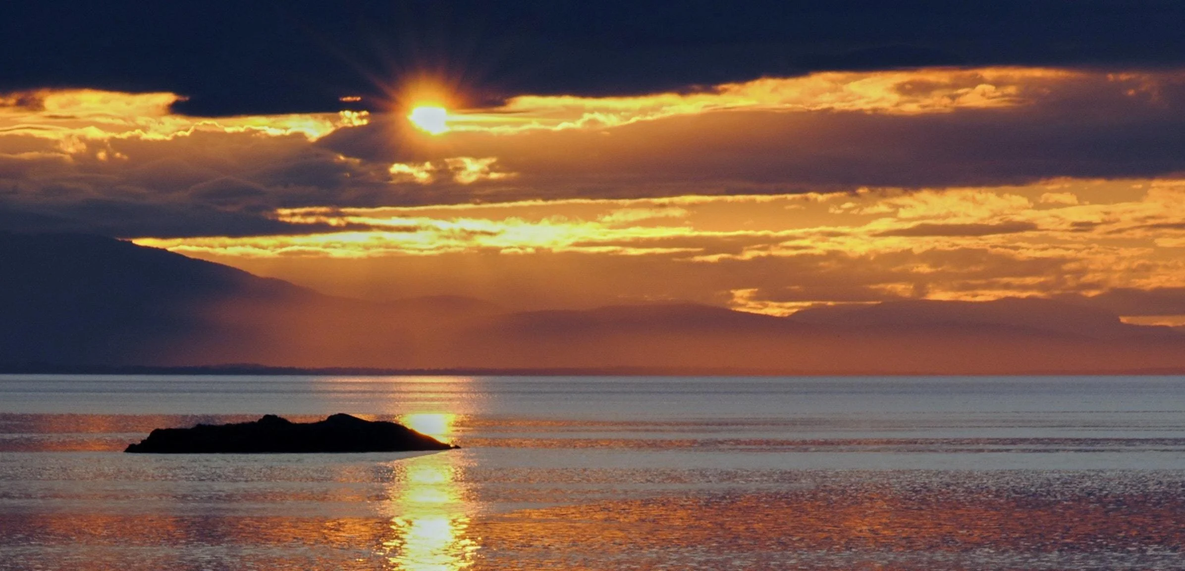 Sunset over water on Lasqueti Island in Gulf Islands, BC