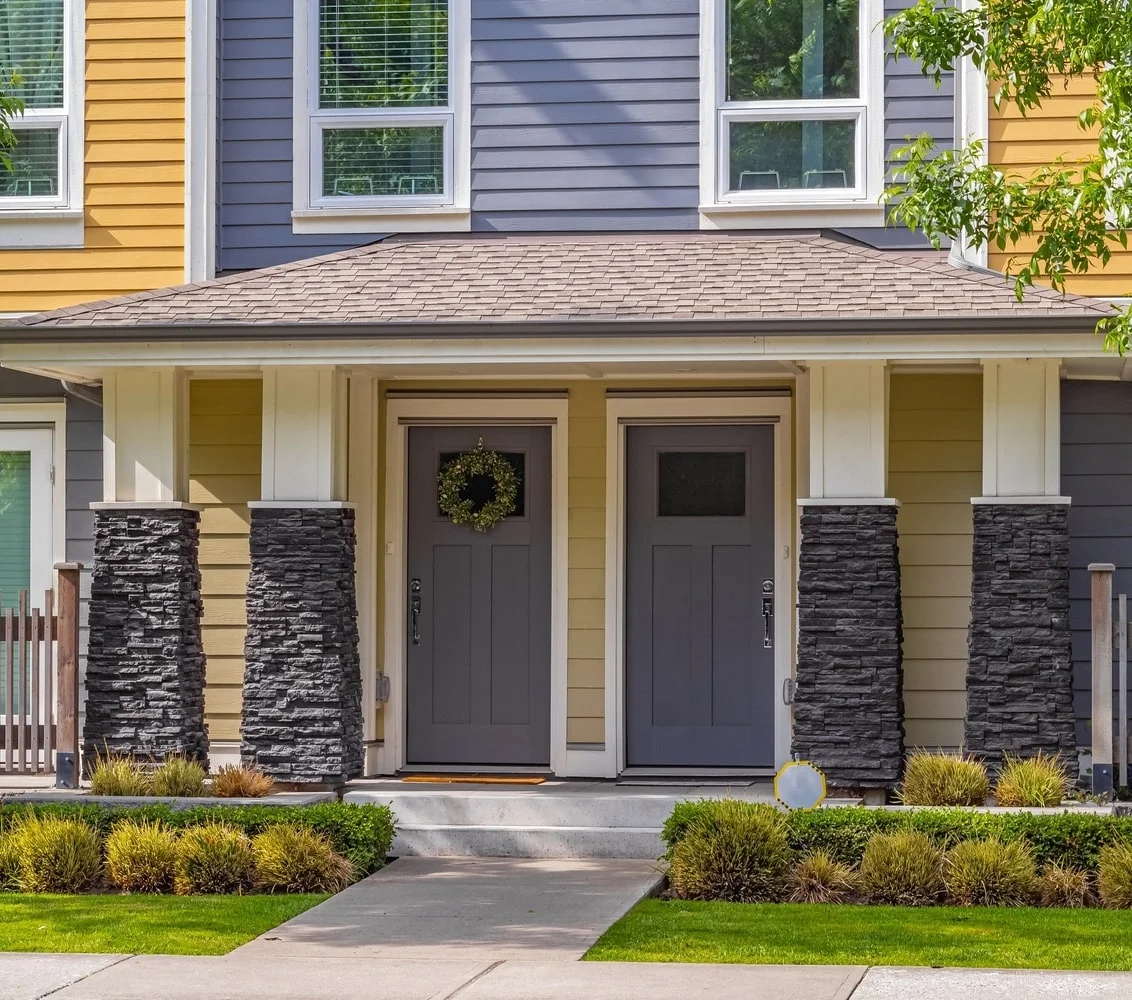 Front doors of colourful, traditional-style townhouses