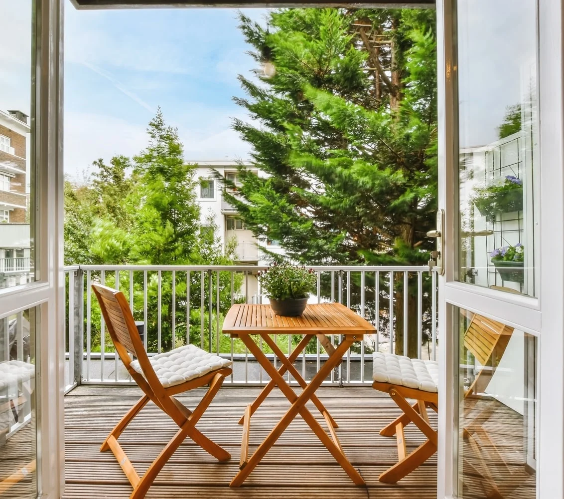 Two chairs on apartment balcony of a small condo complex