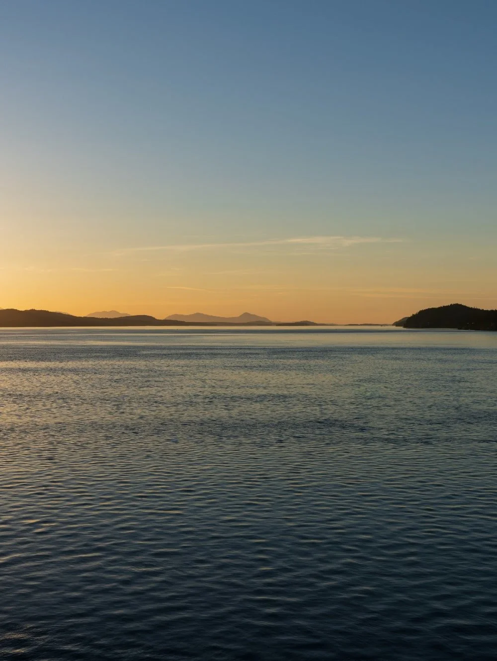 Sunset over islands and water in Lantzville, BC