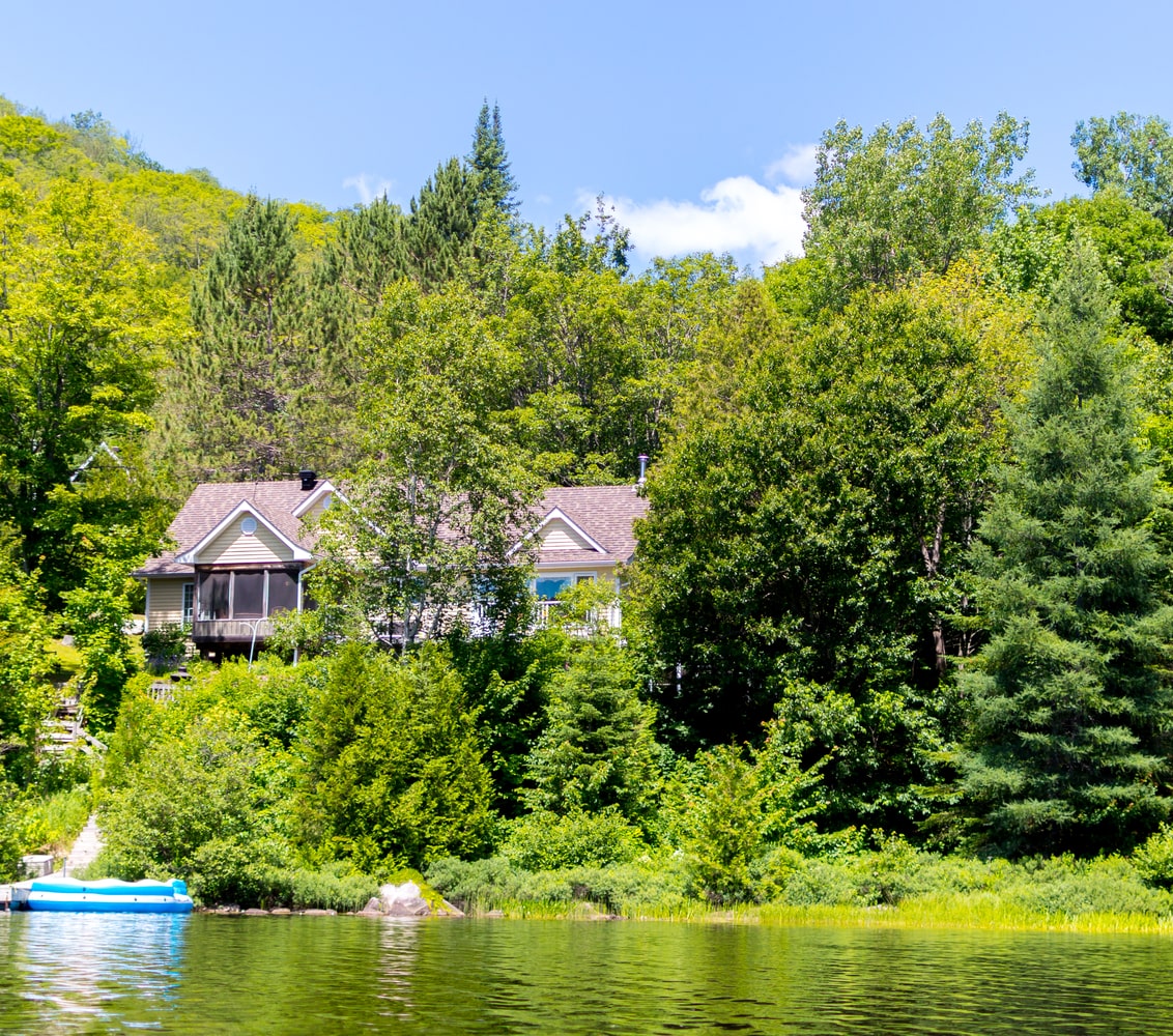 Waterfront home with dock, tucked into the trees