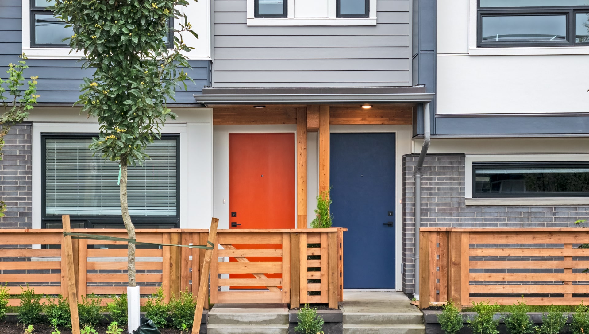 Front doors, red and blue, of new construction townhome