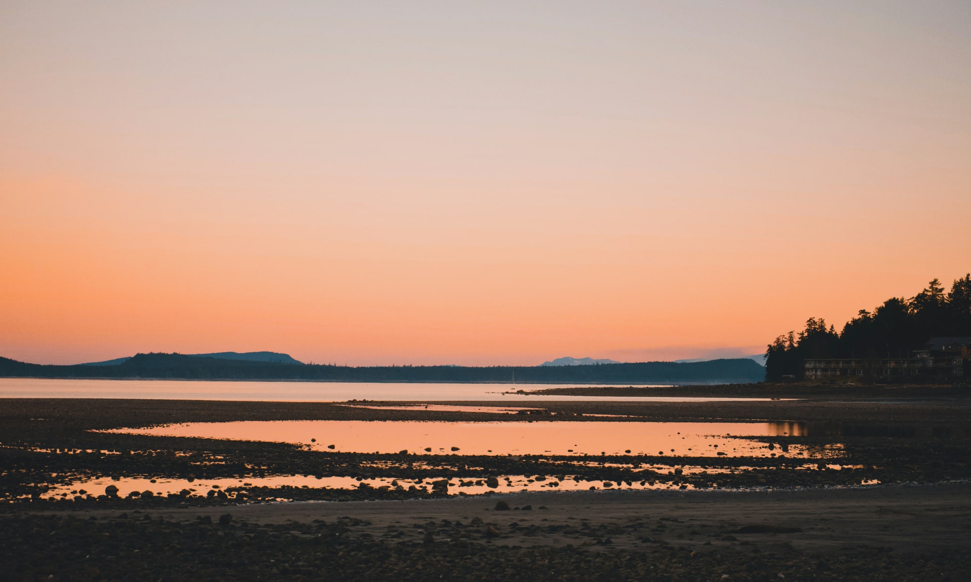 Sunset over rocky beach on Vancouver Island, typical of Deep Bay area. Photo by Cole Freeman on Unsplash.