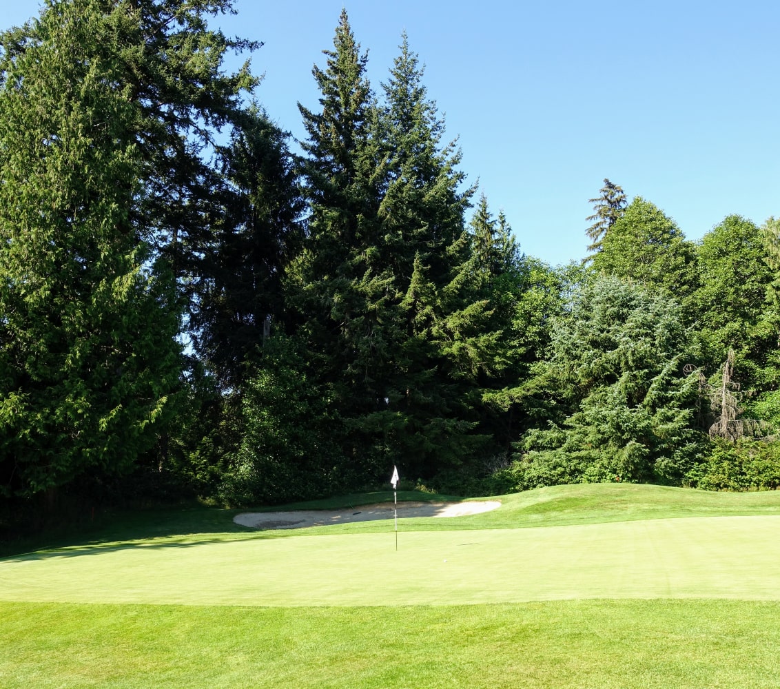 Hole marker on Vancouver Island golf course on a sunny day