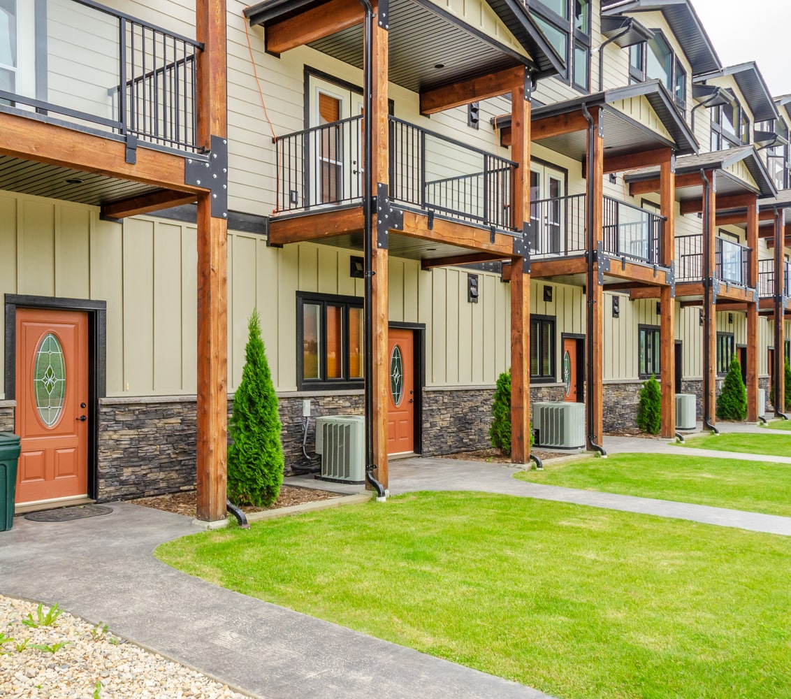 Exterior of row of mid-rise condos, built in a traditional style