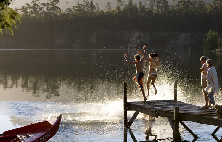 Kids running off of pier and jumping into Vancouver Island lake