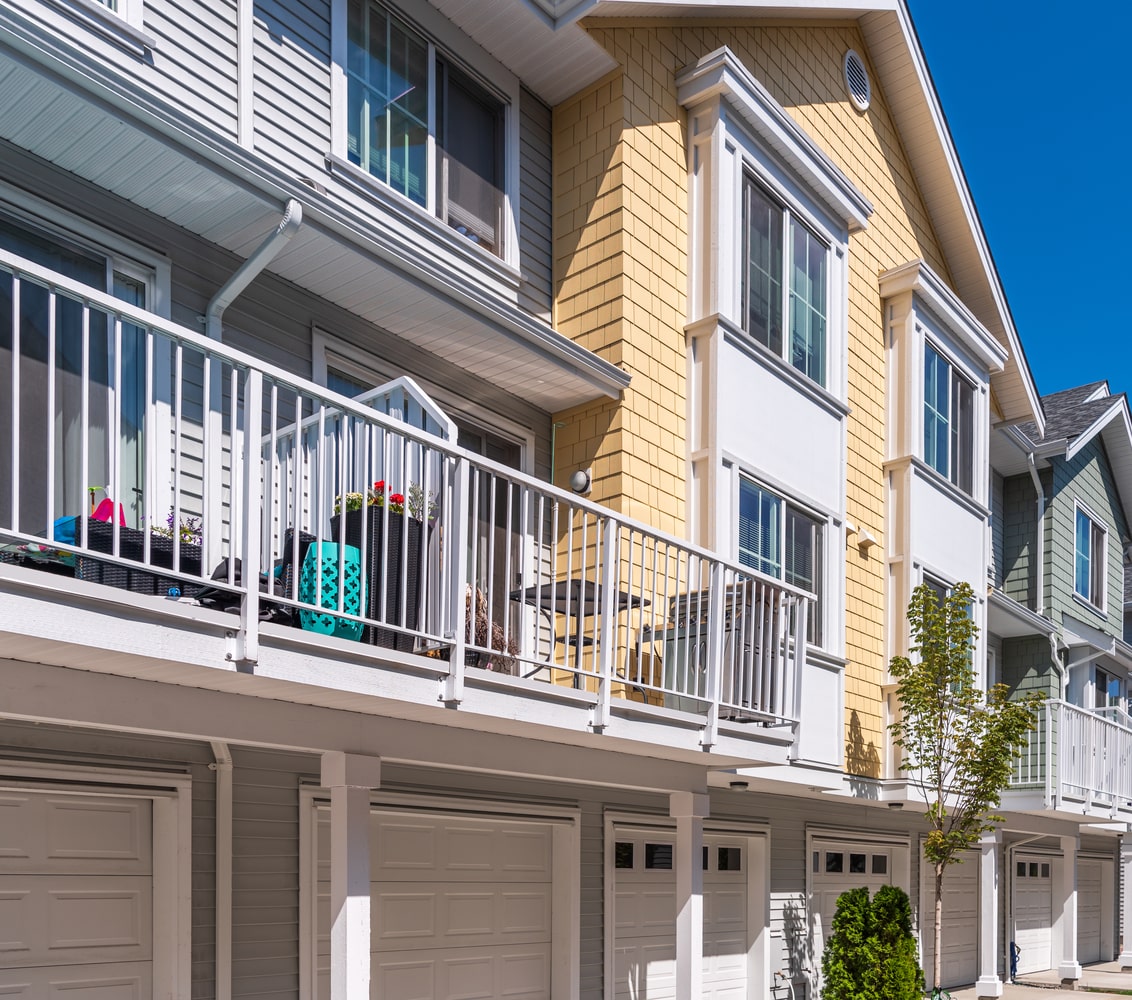 Row of low-rise, colourful, traditional-style apartments